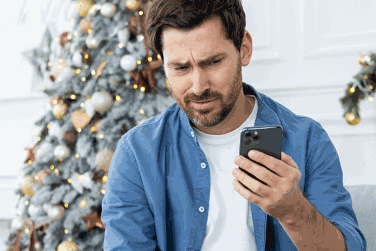 Worried man looking at phone