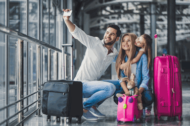 Family taking selfie at airport