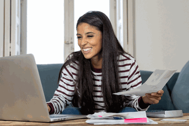 Woman with laptop and bills