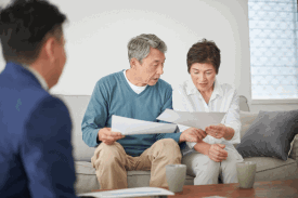 Elder-couple-reviewing-papers-with-Advisor